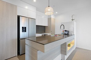 Fridge, microwave, oven, stovetop - Luxe Beachfront 2-Bed With Gym, Pool & Views (Burleigh Heads)