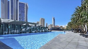 A swimming pool with a cityscape in the background. - Circle on Cavill Luxe 2-Bed with Views & Pool (Surfers Paradise)