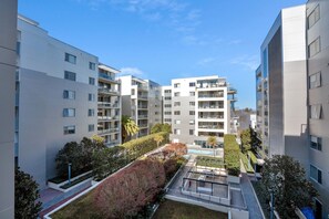 Exterior - Modern 1-Bed Unit with Pool Views and Balcony (City)
