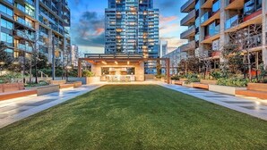 Un immeuble d’appartements moderne doté d’une cour intérieure, entouré d’immeubles résidentiels de grande hauteur.