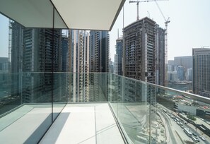 A high-rise building with a glass balcony overlooking a cityscape. - Experience 2BR Luxury Living  LIV Marina (Dubai)