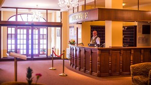 A reception desk with a sign reading "RECEPTION" in a hotel lobby. - Hotel Goethe Spa & Medical (Františkovy Lázně)