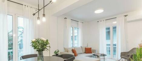 Una sala de estar moderna con una mesa de comedor, sofá y sillas.