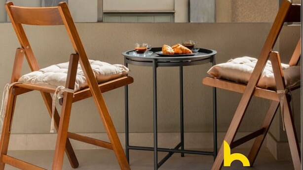 A balcony with two wooden chairs, a small round table, and a window with blinds. - Luxurious Zen Retreat W/Balcony & 300mbps WiFi (Athina)