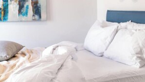 A bedroom with a bed, pillows, a blanket, a wall art piece, and a wall decor. - Upscale central APT, Patio near Hospitals & Metro (Μενεμένη)