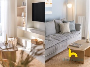 Een moderne woonkamer met een grijze bank, een flatscreen televisie aan de muur, een ronde houten salontafel en een vloerlamp.