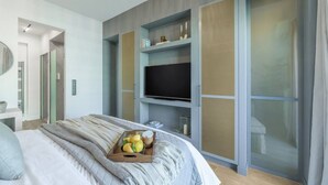 A modern bedroom with a bed, a TV on a built-in shelf, and a sliding door. - 50 Shades of Athens, Kingsize Suite with Jacuzzi! (Athina)