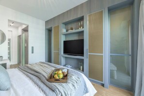 A modern bedroom with a bed, a TV on a built-in shelf, and a sliding door. - 50 Shades of Athens, Kingsize Suite with Jacuzzi! (Athina)