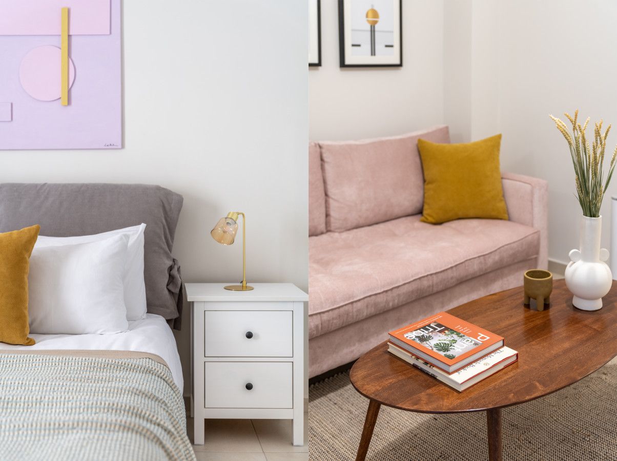 A bedroom with a bed, bedside table, lamp, and a nightstand.