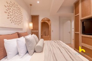 A modern bedroom with a bed, pillows, a wall art piece, a TV, and a wooden wardrobe. - Acropolis Zen Oasis romantic retreat in Koukaki! (Athina)