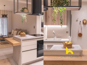 A modern kitchen with a central island, a built-in oven, and a hanging plant. - Charming Boho haven Luxurious escape in Thisseio! (Athina)