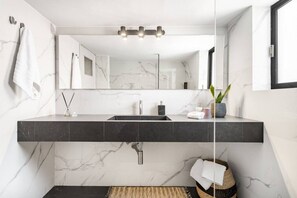 A modern bathroom with a marble vanity, a large mirror, and a black sink. - Acropolis View, Minimal-Safari Vibe, Big Balcony! (Athina)