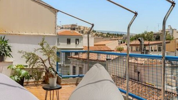 A rooftop terrace with a table, two cushions, and a view of the cityscape. - Acropolis View, Minimal-Safari Vibe, Big Balcony! (Athina)