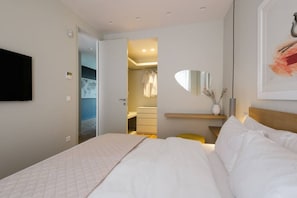 A hotel room with a bed, a bedside table, a mirror, and a wardrobe. - Kalypso, Urban APT w/ Unique Views of Acropolis! (Athina)