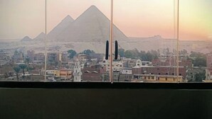 A view of a cityscape with pyramids in the background. - Modern Deluxe Studio by the Pyramids – Comfort & Style in Giza (Giza Governorate)