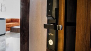 A modern door with a built-in control panel, a wooden frame, and a glass panel. - Modern Deluxe Studio by the Pyramids – Comfort & Style in Giza (Giza Governorate)