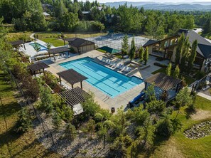 A residential property with a swimming pool, lounge chairs, and a view of the surrounding landscape. - Bright & Comfortable Park City Retreat | Seasonal & Month-Long Stays (Park City)