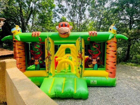 An inflatable play structure with animal-themed designs.
