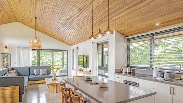 A modern kitchen with a large island, wooden ceiling, and large windows. - Villa Bernard - luxurious home in Tamarindo, walking distance to the beach& town (Tamarindo)