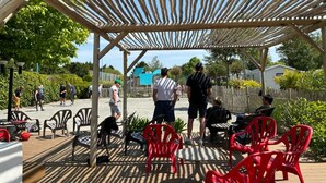 An outdoor patio with wooden pergola, red plastic chairs, and tables. - Cozy chalet with terrace in Saint-Jean-de-Monts (Saint-Jean-de-Monts)