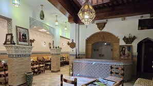 A spacious lobby with wooden beams, patterned tiles, and hanging lanterns. - RIAD RAHBA FEZ (Fes)