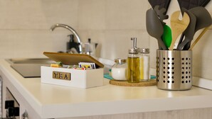 Keittiön työtasolla on teelaatikko, öljypullo ja astioiden säilytysastia.