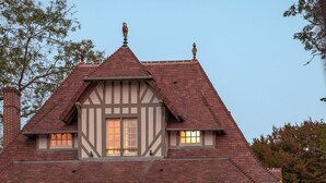 A large, two-story Tudor-style house with a prominent gabled roof and a balcony. - Villa des Reves Luxury in Villers Pool Jacuzzi Padel Court Close to Deauville (Villers-sur-Mer)