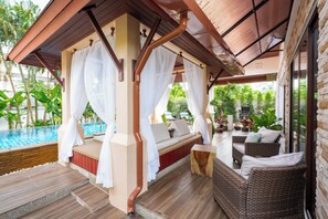 A covered outdoor seating area with a pool, wicker furniture, and a canopy. - Villa Amida • Balinese Pool Villa • Big Sala & Terrace • Nai Harn & Rawai Beach (Tambon Rawai)