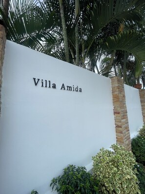 A sign for 'Villa Amida' with a white wall and brick pillars. - Villa Amida • Balinese Pool Villa • Big Sala & Terrace • Nai Harn & Rawai Beach (Tambon Rawai)