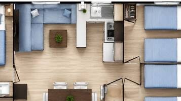 Ett kompakt bostadsutrymme med en soffa, ett matbord, ett litet kök och ett litet badrum.