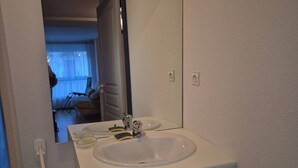 A bathroom with a white sink, mirror, and cabinet. - Charming T2bis 4-6 people, near center, Cauterets (Cauterets)