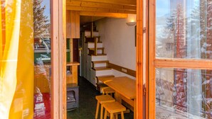 A wooden interior with a dining area, wooden benches, and a staircase leading to an upper level. - Apartment Arc 1800 - 5 pers, Loft, Pets Allowed (Les Arcs 1800)