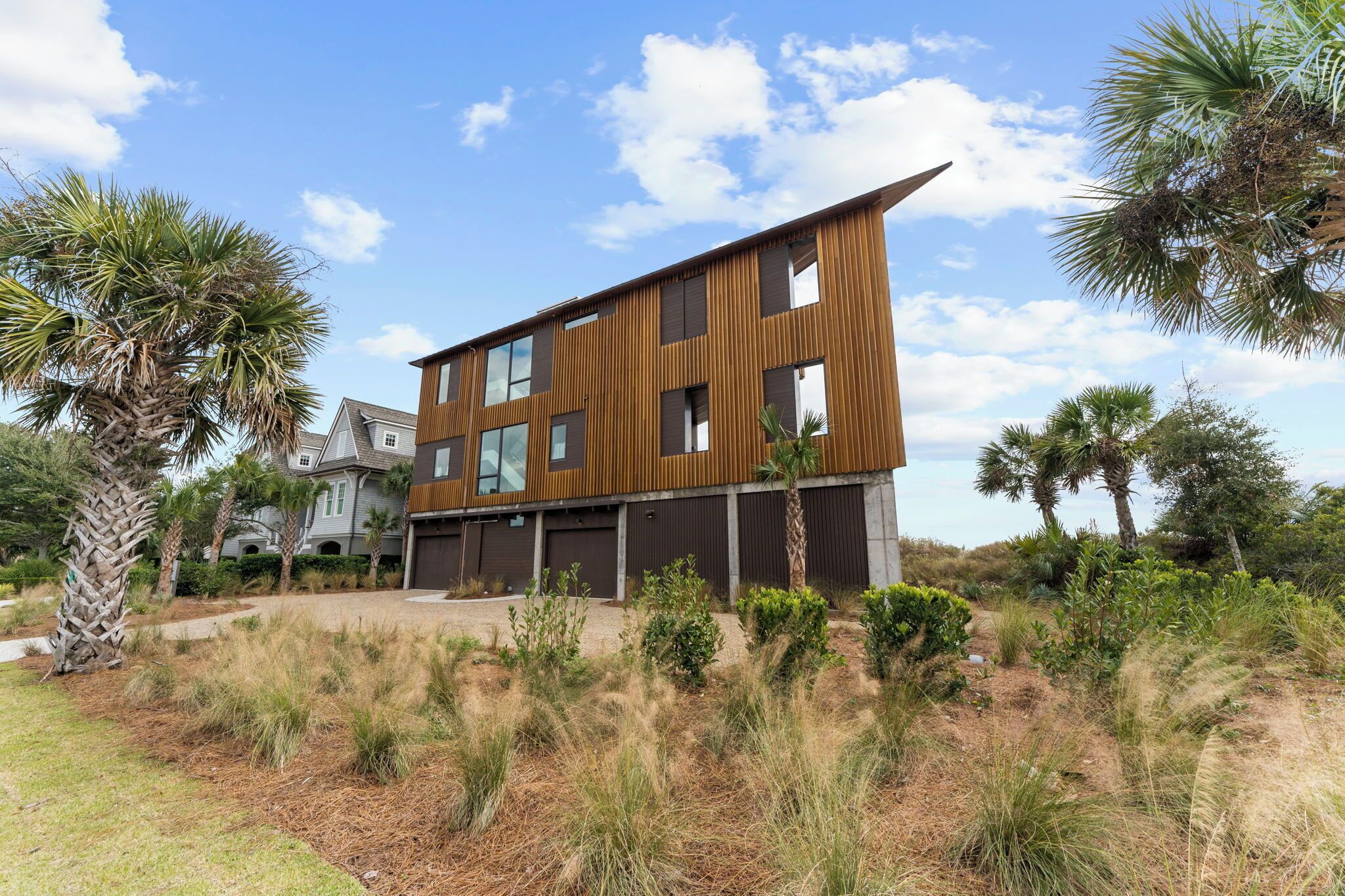A modern two-story building with a flat roof and large windows.