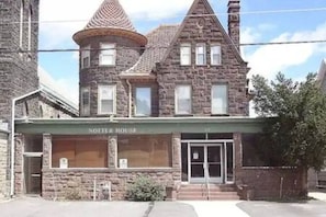 A stone building with a turret and a sign reading 'Notter House.'