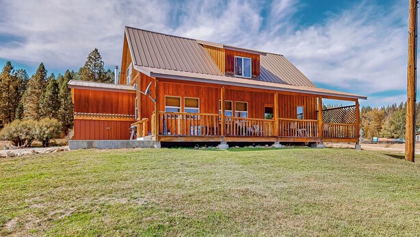 A wooden cabin with a porch, a covered deck, and a metal roof. - 3BR Rustic Cabin w/ 2 Decks & Hot Tub (Garden Valley)