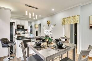 A modern kitchen with stainless steel appliances and a dining area with a central island. - 2 Mi to Downtown: Charming Apt in Schenectady! (Schenectady)