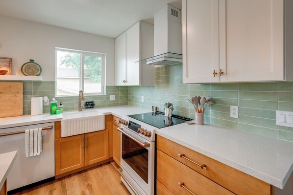 A kitchen with wooden cabinets, a white countertop, a stove, and a window. - 2 Mi to Dtwn: Gorgeous Gilbert Gem w/ Private Yard (Gilbert)
