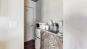 A compact kitchenette with a microwave, coffee maker, and storage containers. - 'bamboo Hideaway' in Cardiff w/ Outdoor Space (Cardiff-by-the-Sea)