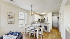 A spacious kitchen with a dining area, wooden flooring, and a chandelier. - 2BR Condo on Golf Course w/ Pool & Tennis Court (Myrtle Beach)