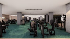 Une salle de sport spacieuse, équipée de divers appareils d’exercice et dotée d’espaces de repos.