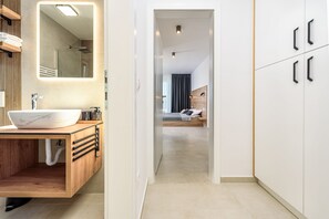 A modern bathroom with a large mirror, a wooden vanity, and a white sink. - Villa The Family Zadarvillas (Jasenice)