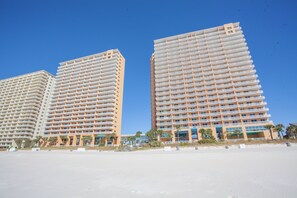 Two high-rise hotels with multiple balconies, located on a beach with clear skies. - Splash Resort 1701E • Beachfront 3BR • Sleeps 10 • Pools & Waterpark (Panama City Beach)