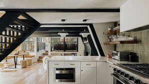 Una cocina moderna con una isla central, horno integrado y estufa.