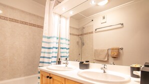 A bathroom with two sinks, a shower, wooden cabinets, a towel rack, and a mirror. - Splendid apartment, 3 bedrooms, sleeps 6, balcony with mountain views (Morillon)