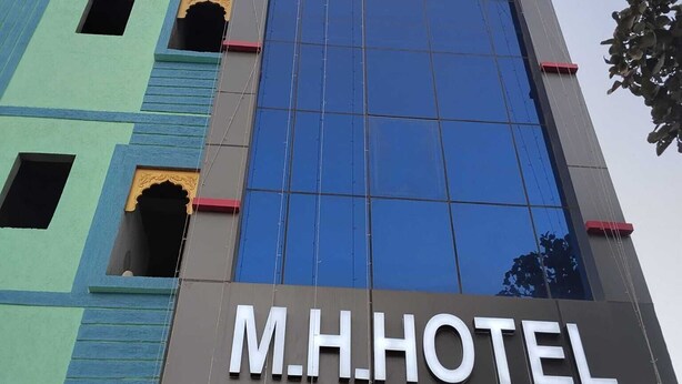 A hotel building with a prominent sign reading "M.H. HOTEL". - Manbhar Heavens Hotel (Amer)