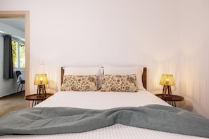 A neatly made bed with two pillows, two bedside lamps, and a grey throw blanket. - Destiny s Village II (Zakynthos)