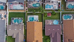 An aerial view of a residential area with multiple houses, each with a swimming pool. - Sunshine Serenity Villa (Kissimmee)