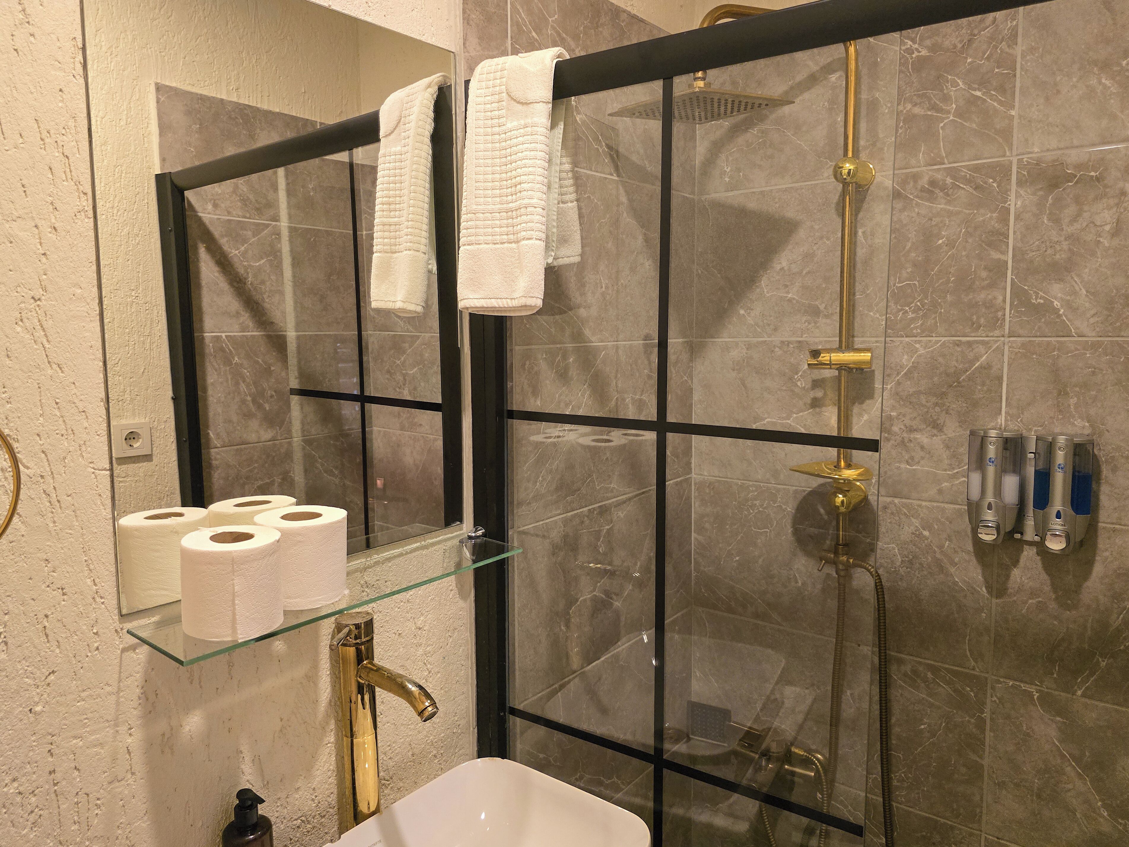 Shower, hair dryer, slippers, towels