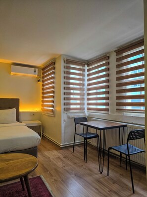 Standard Triple Room | Living area | 22-inch flat-screen TV with cable channels - Karaköy Port House  (Istanbul)