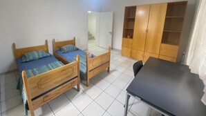 A room with two wooden beds, a wardrobe, and a table. - Tirana • 2 Single Beds • Free Wi-Fi • Pet-Friendly • Shared Kitchen & Bathroom (Tiarana)